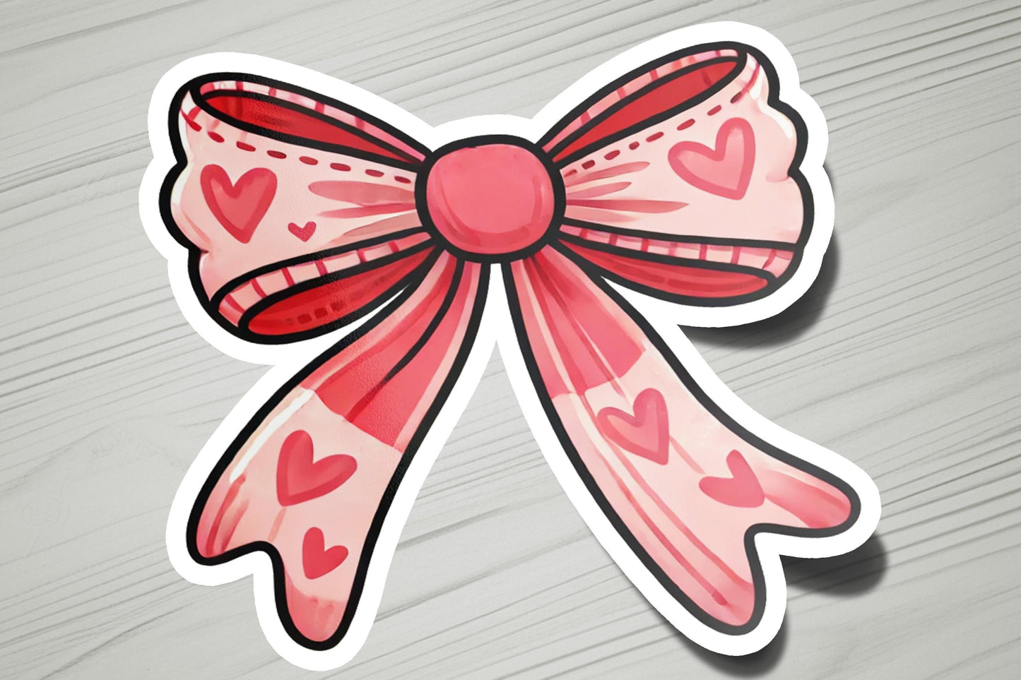 a sticker of a pink bow with hearts on it