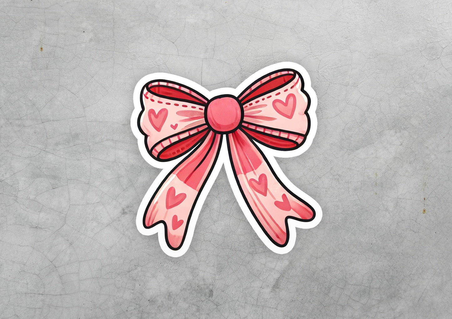 a sticker of a pink bow with hearts on it