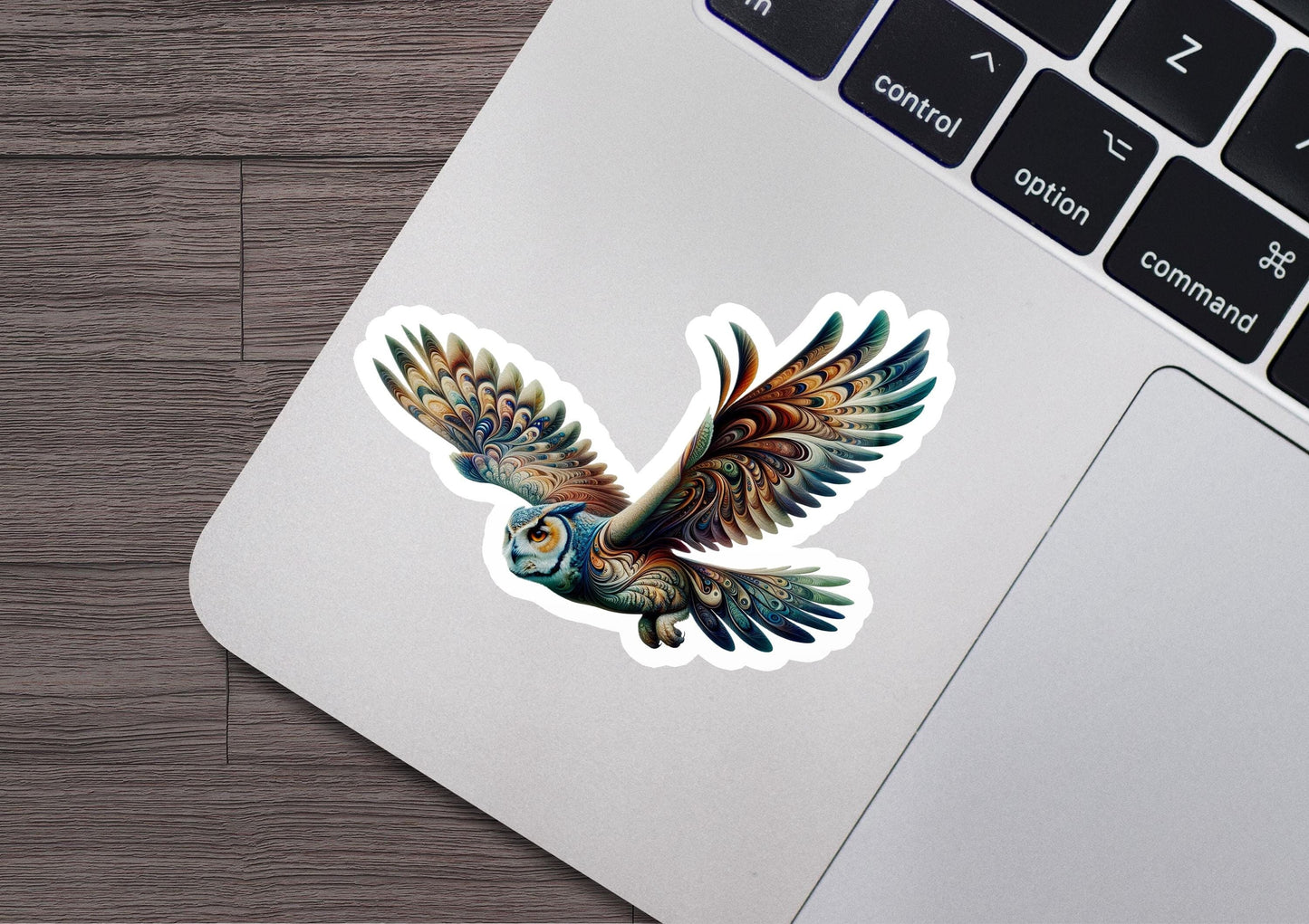 a laptop with a sticker of a bird on it