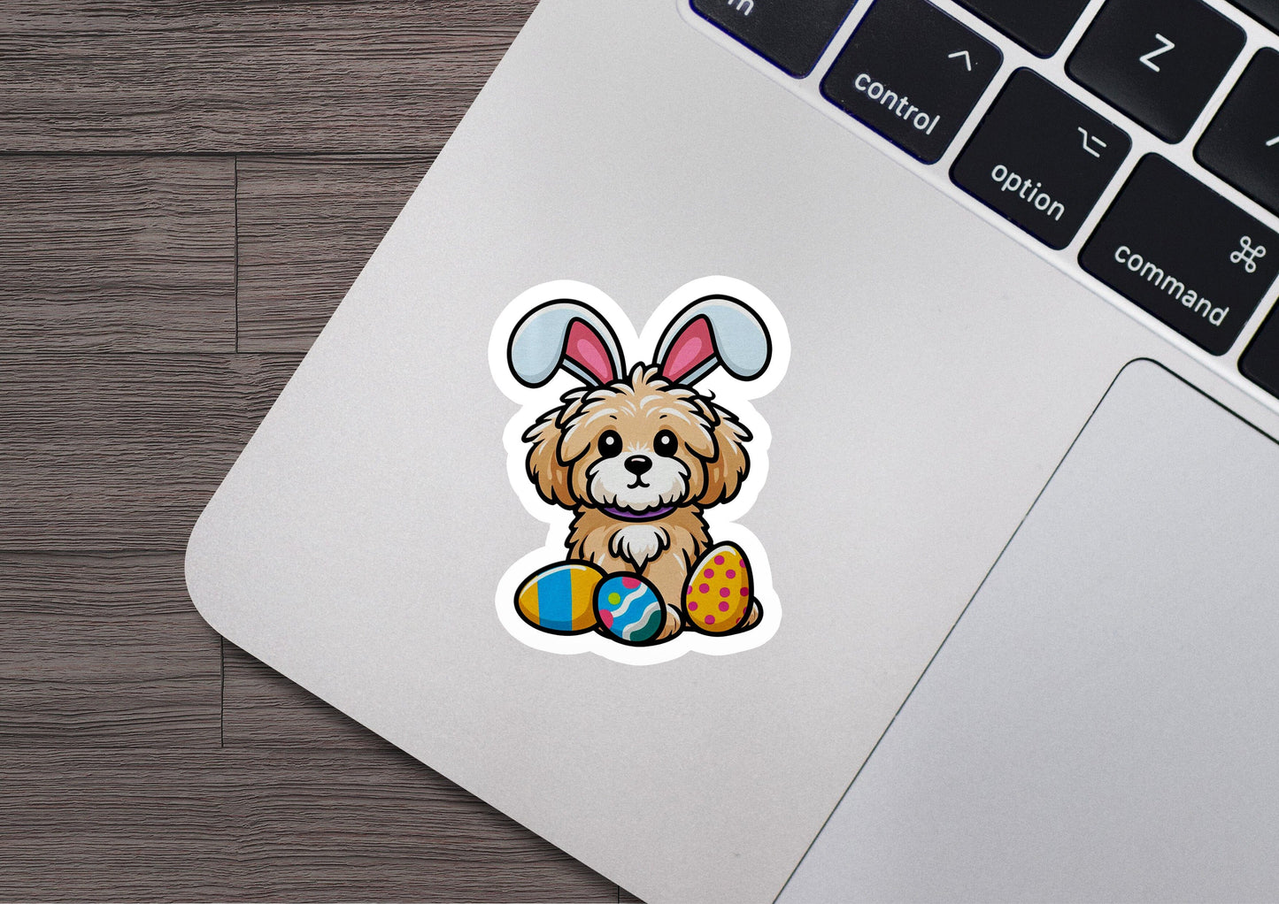 a laptop with a sticker of a dog with bunny ears