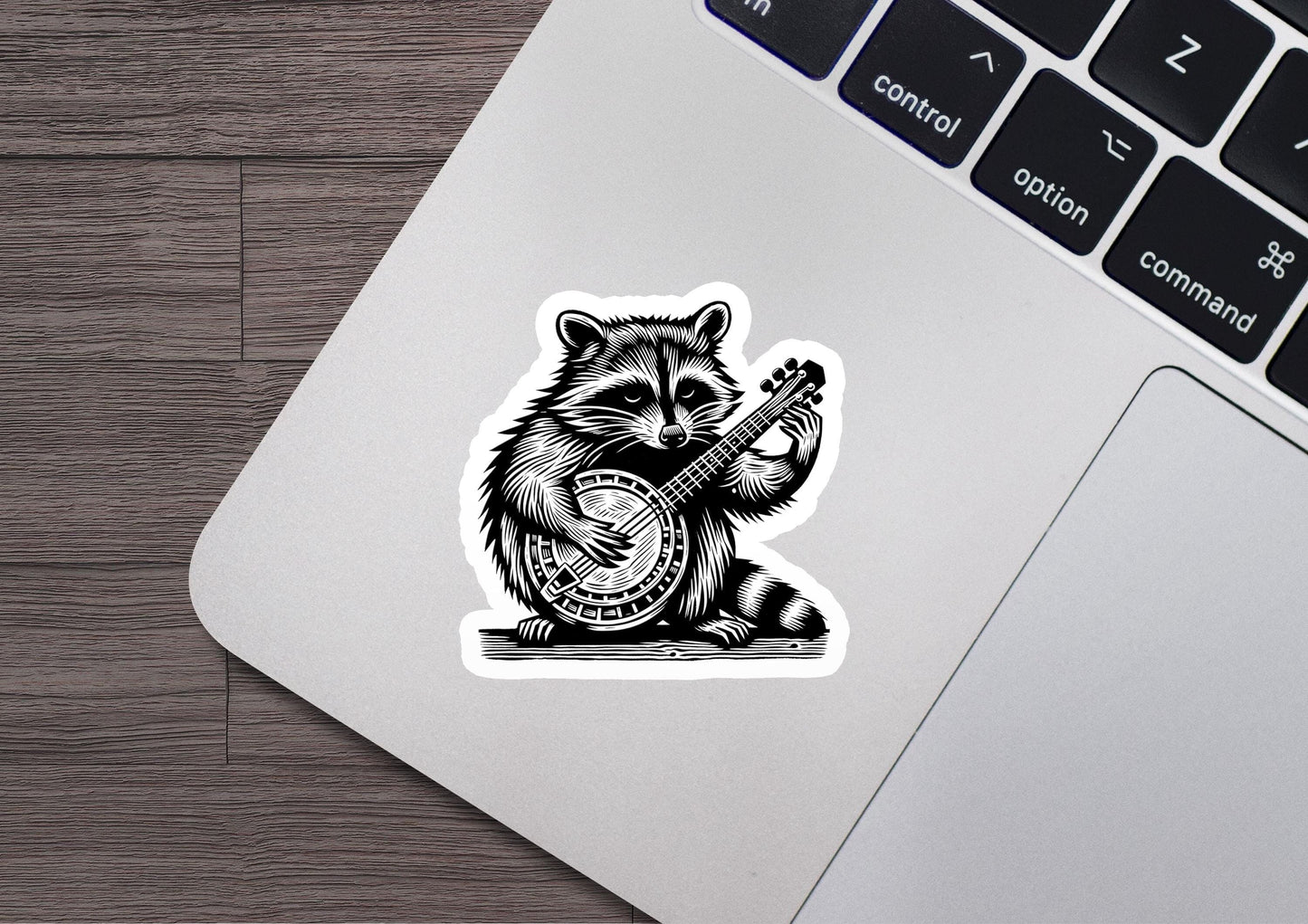 a sticker of a raccoon playing a guitar