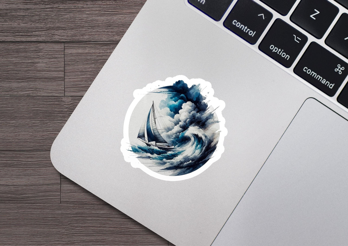 a laptop with a sticker of a boat in the ocean