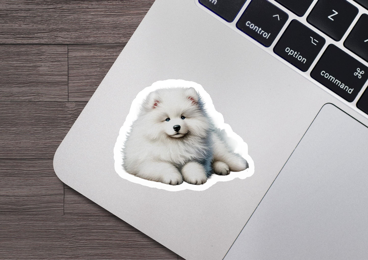 a sticker of a small white dog sitting on top of a laptop