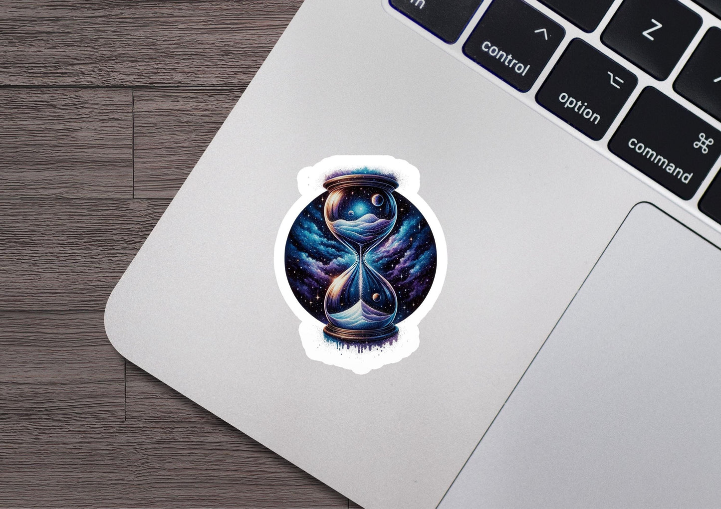 a laptop with a sticker of an hourglass