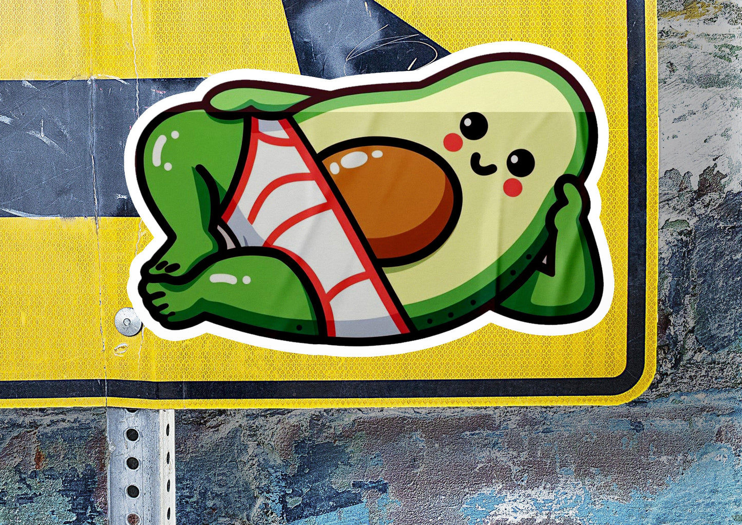 a close up of a street sign with a sticker of an avocado