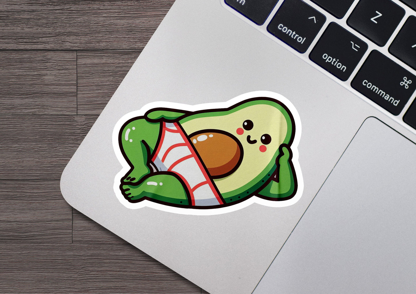 an avocado sticker on a laptop computer