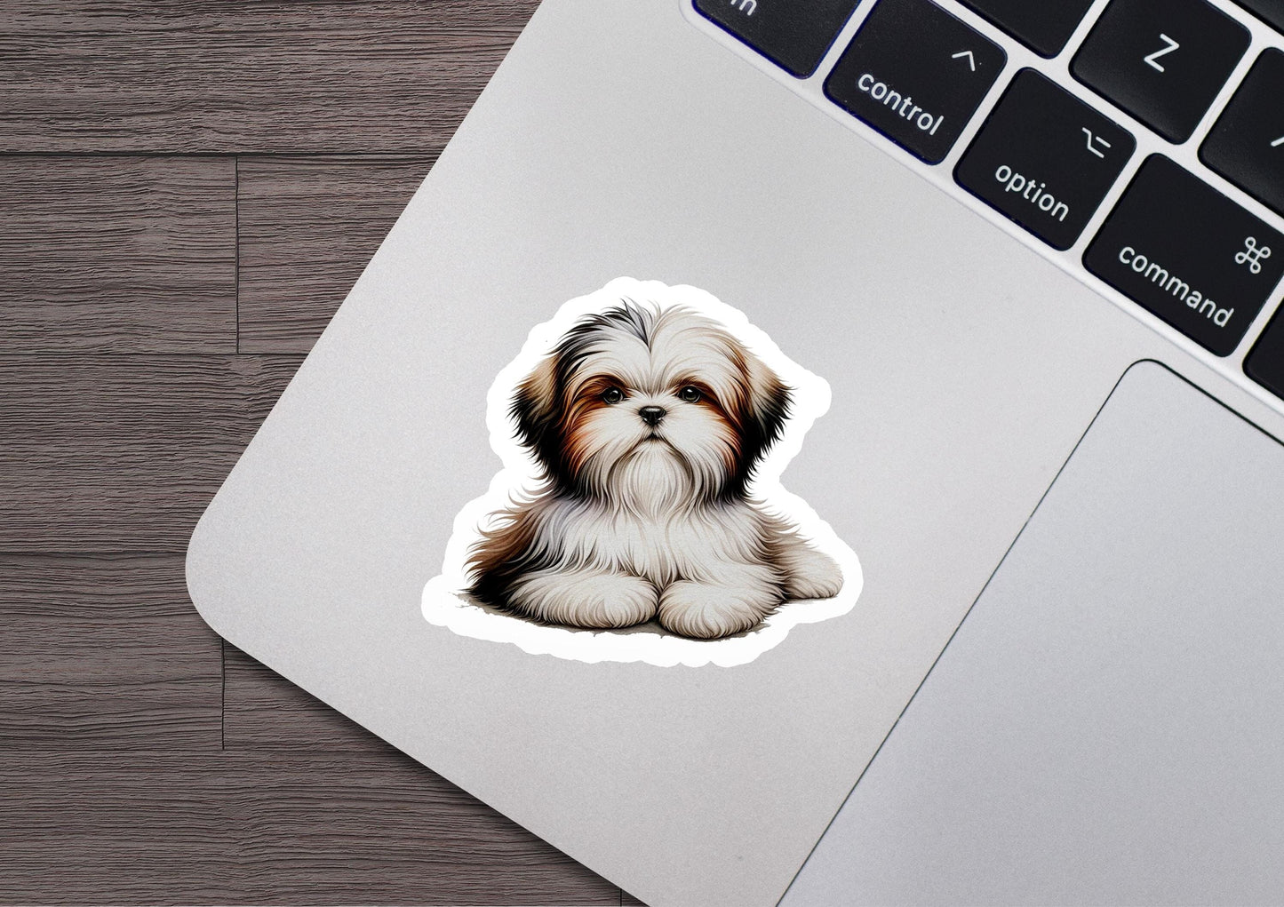 a sticker of a dog sitting on top of a laptop