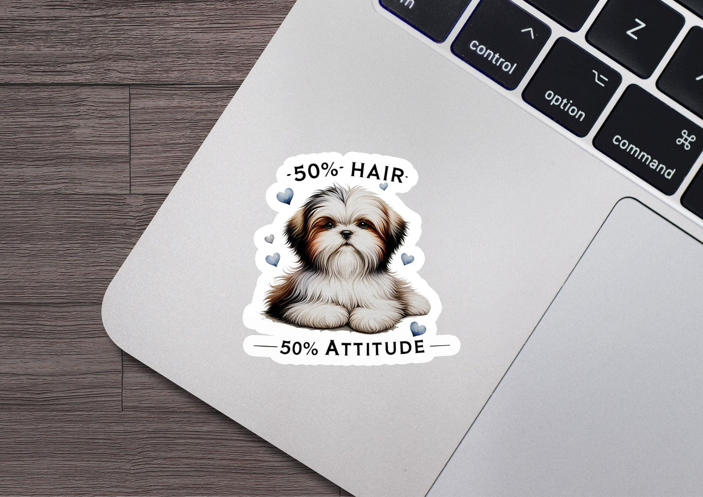 a sticker of a dog sitting on top of a laptop
