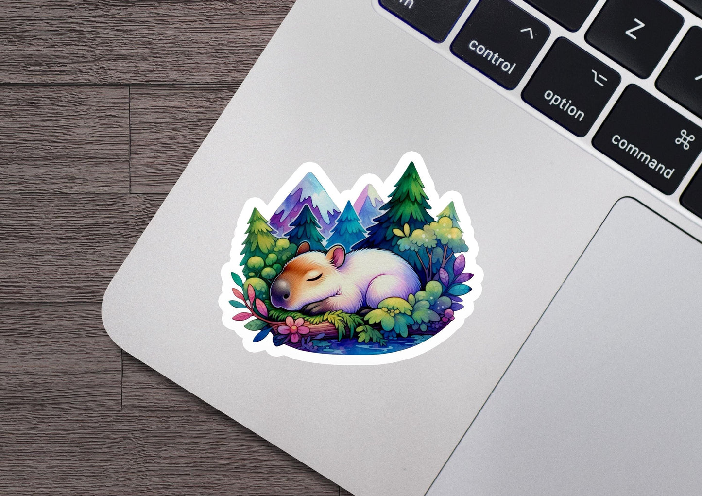 a sticker of a sleeping hamster in a forest