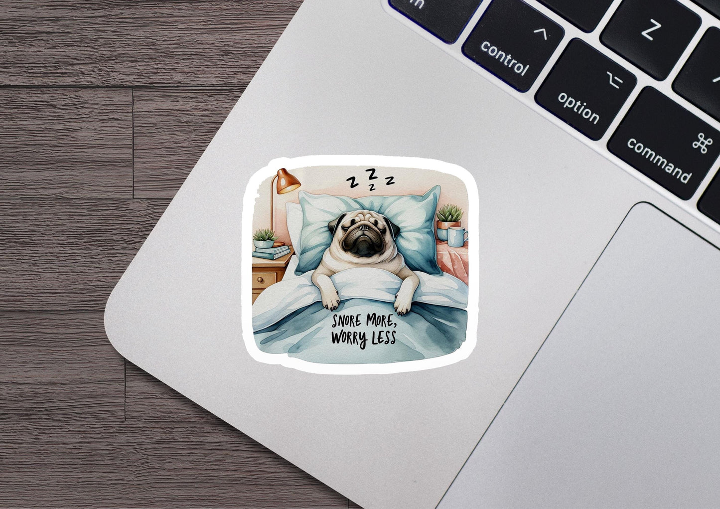 a sticker of a pug dog sleeping on a bed
