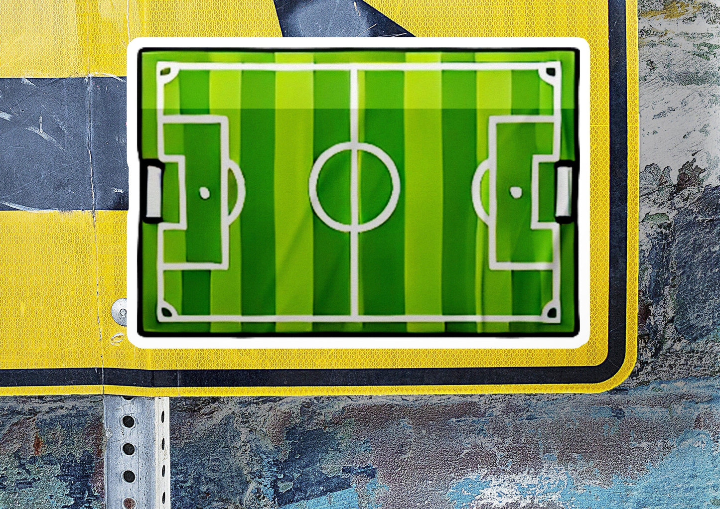 a green and yellow sign with a soccer field on it