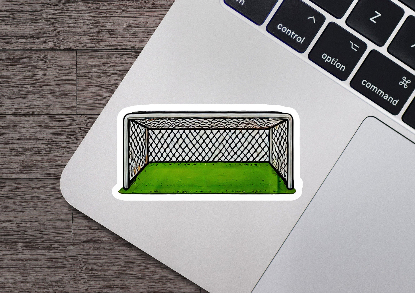 a laptop with a sticker of a soccer goal