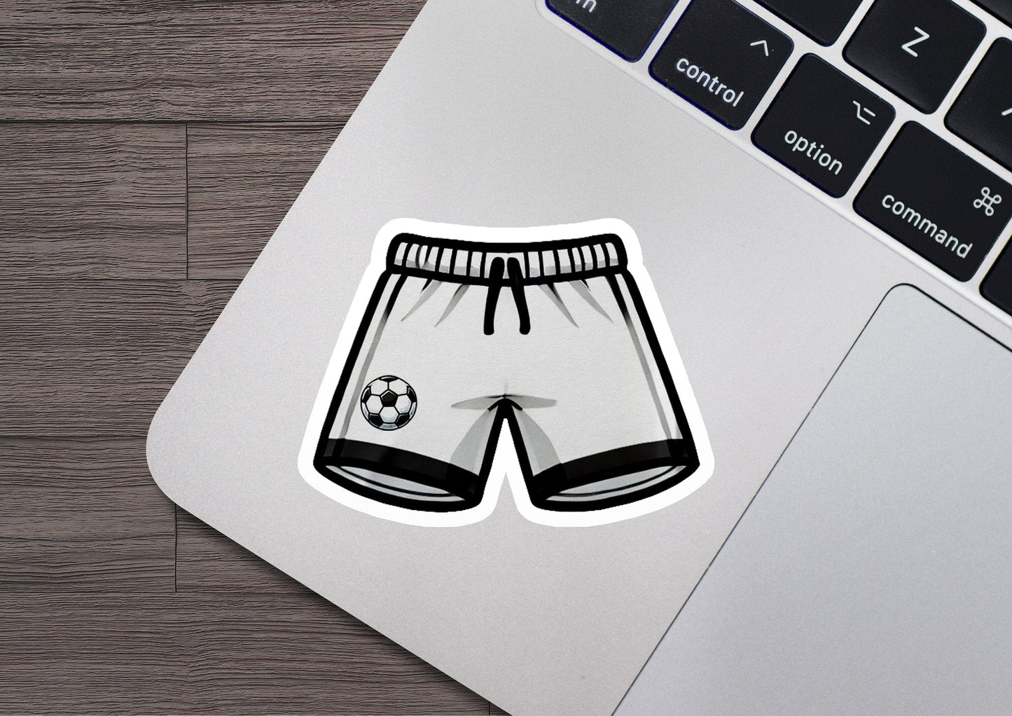 a laptop with a sticker of a soccer shorts