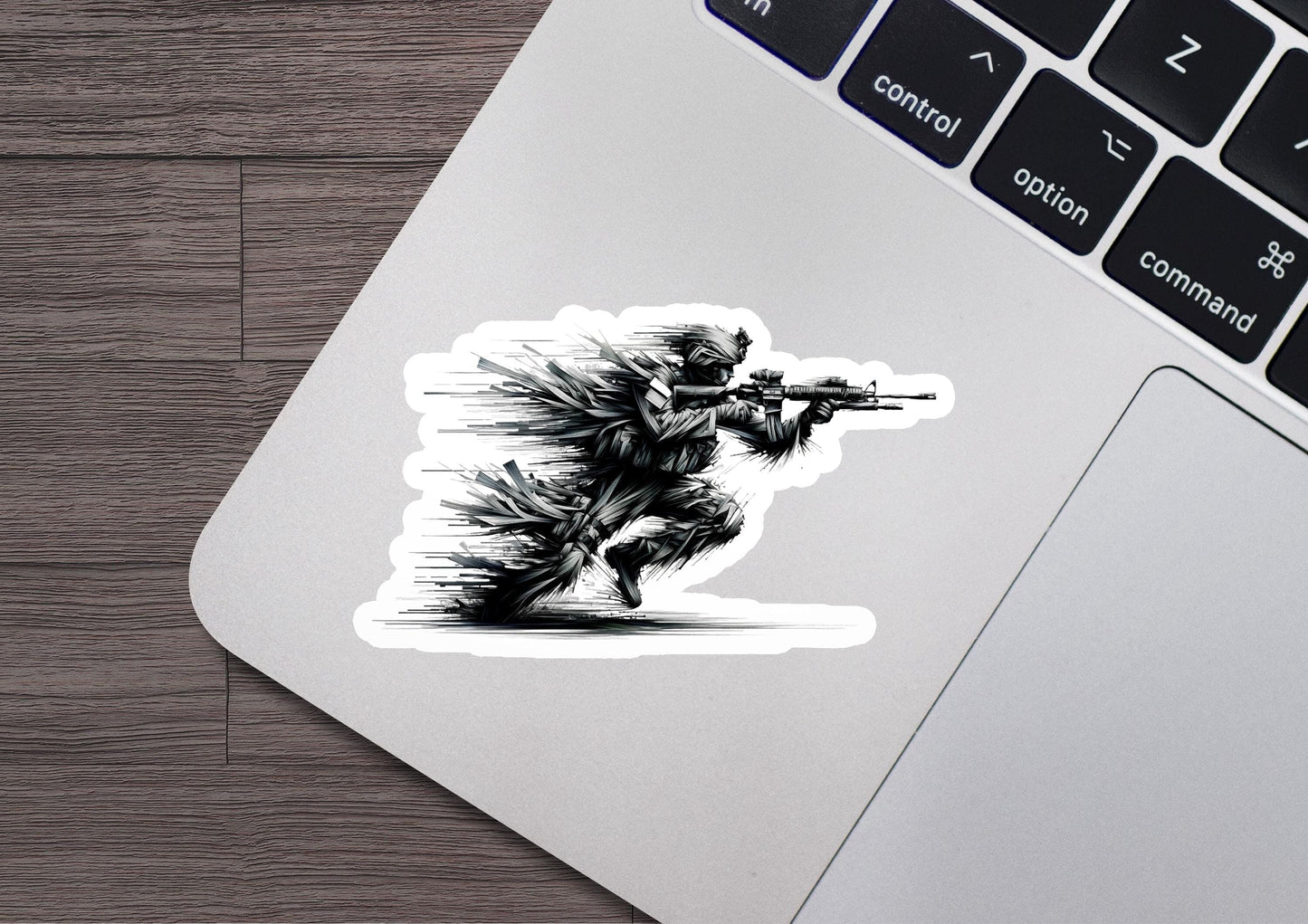 a sticker of a man with a gun on a laptop