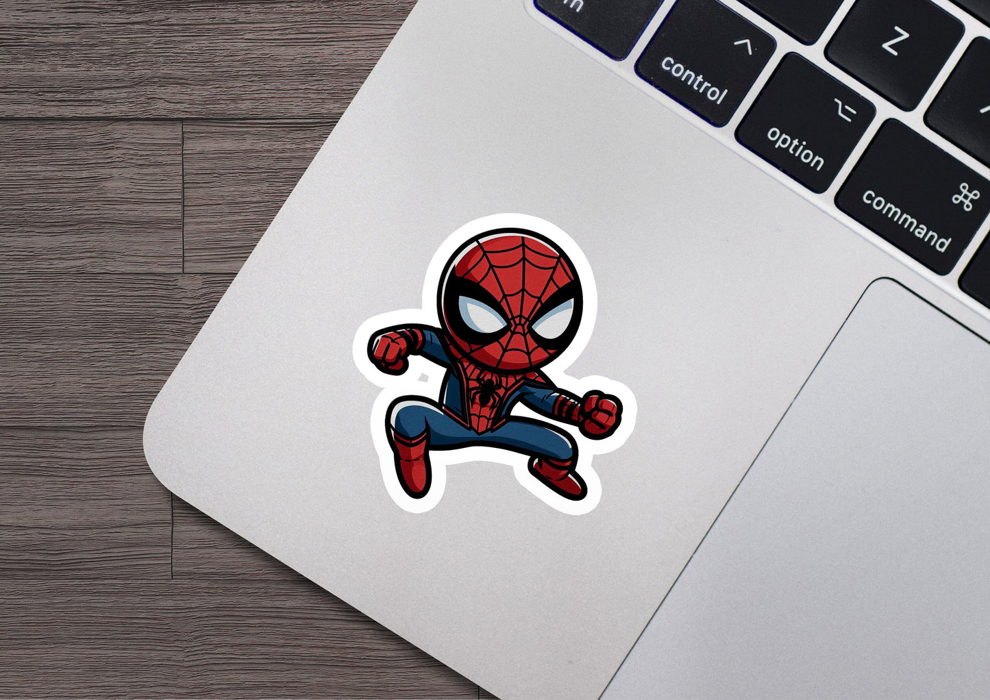 a laptop with a sticker of a spider man