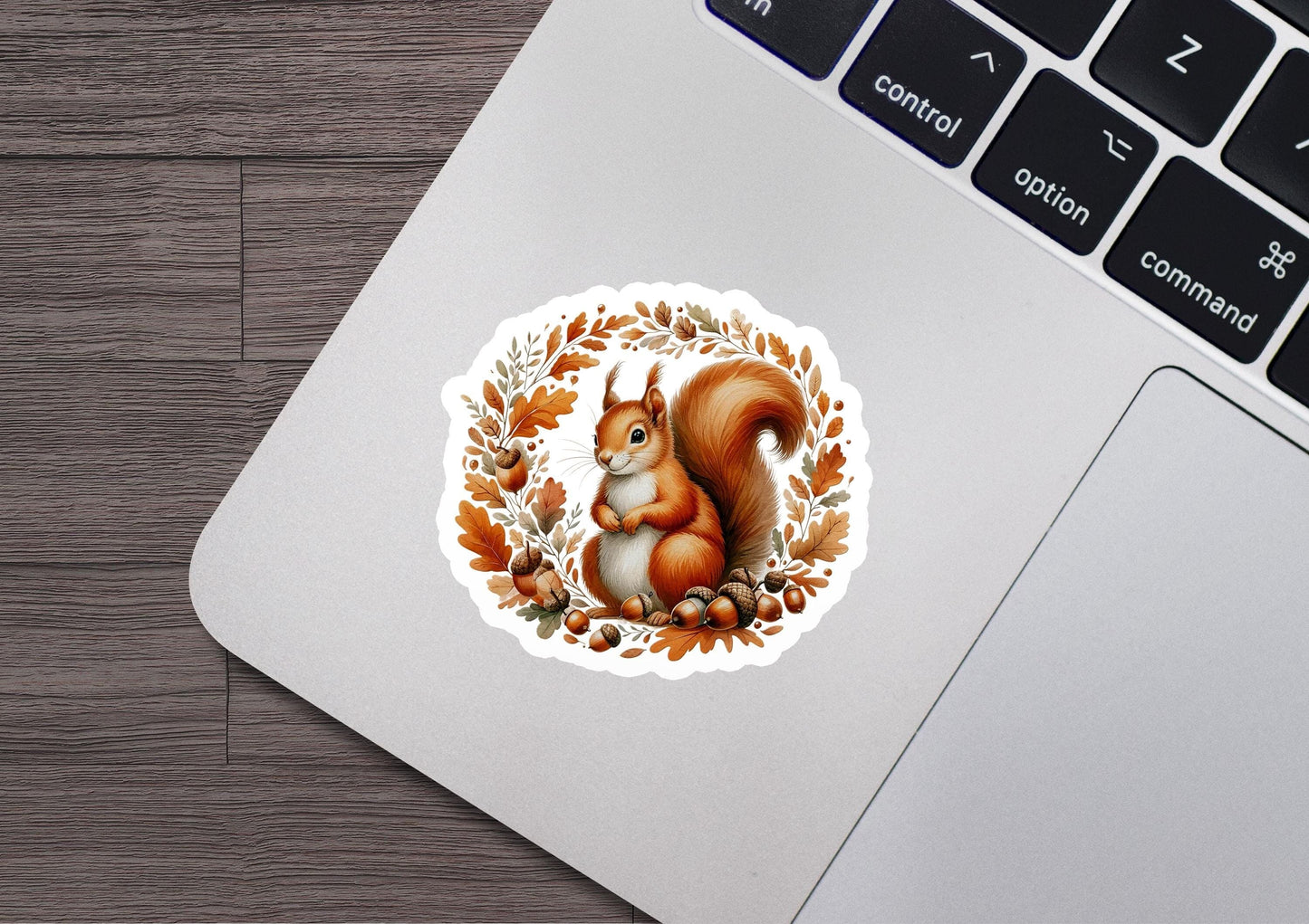 a sticker of a squirrel sitting on top of a laptop