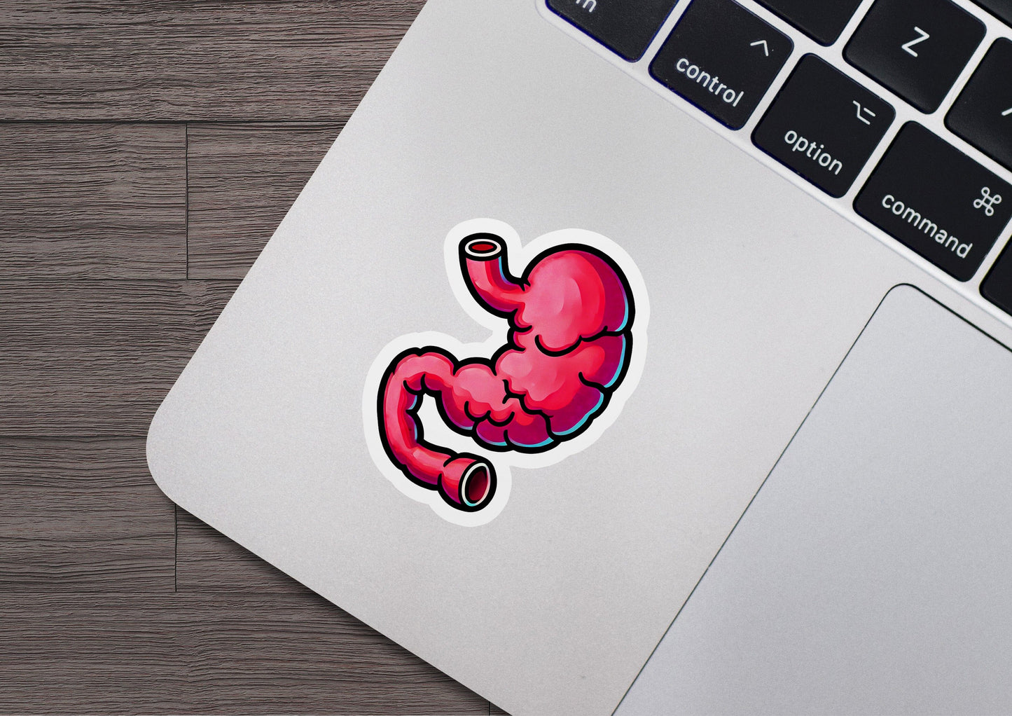 a laptop with a sticker of a stomach on it