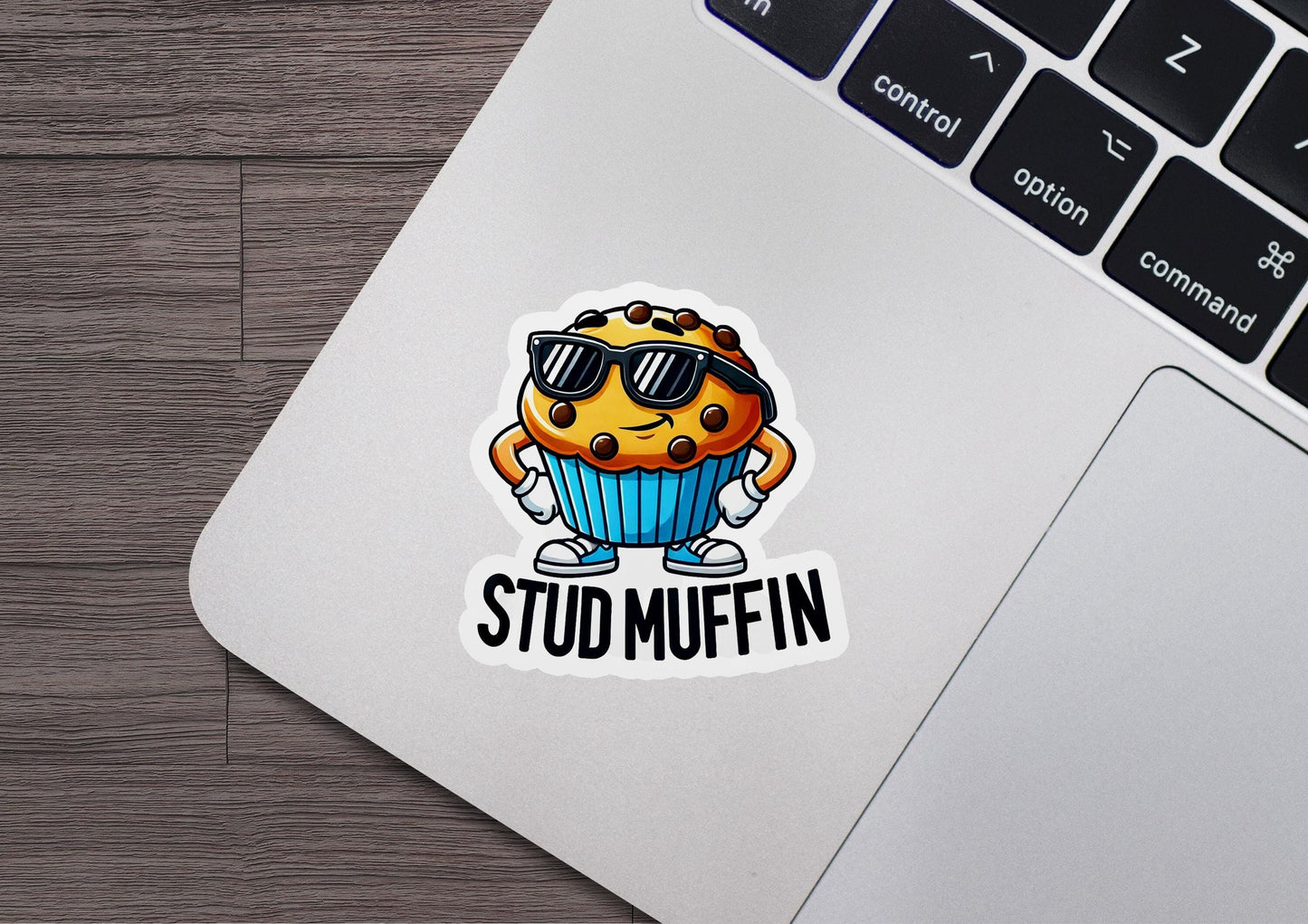 a sticker that says stud muffin in front of a laptop