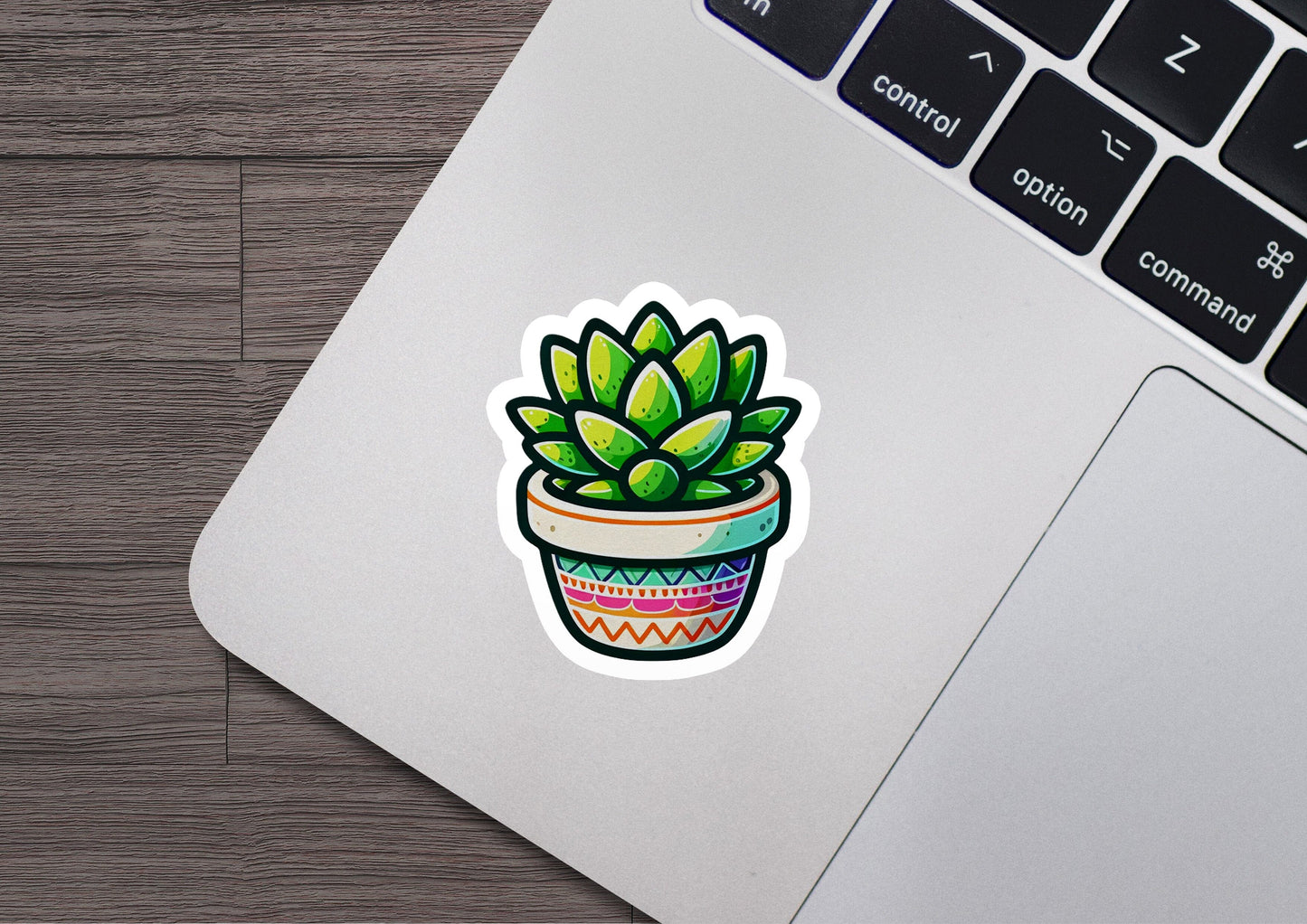 a laptop with a sticker of a potted plant