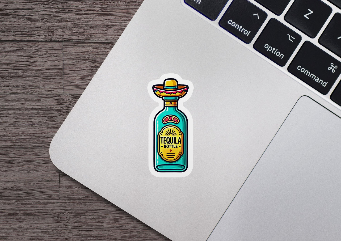 a laptop with a sticker of a bottle of tequila