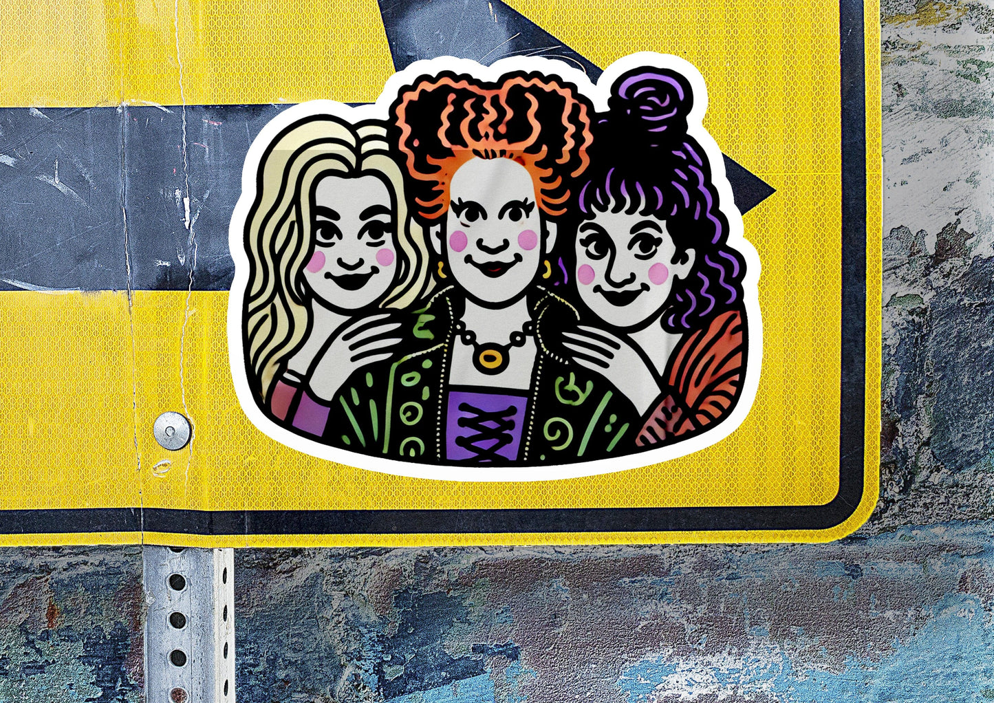 a sticker of three women on a street sign