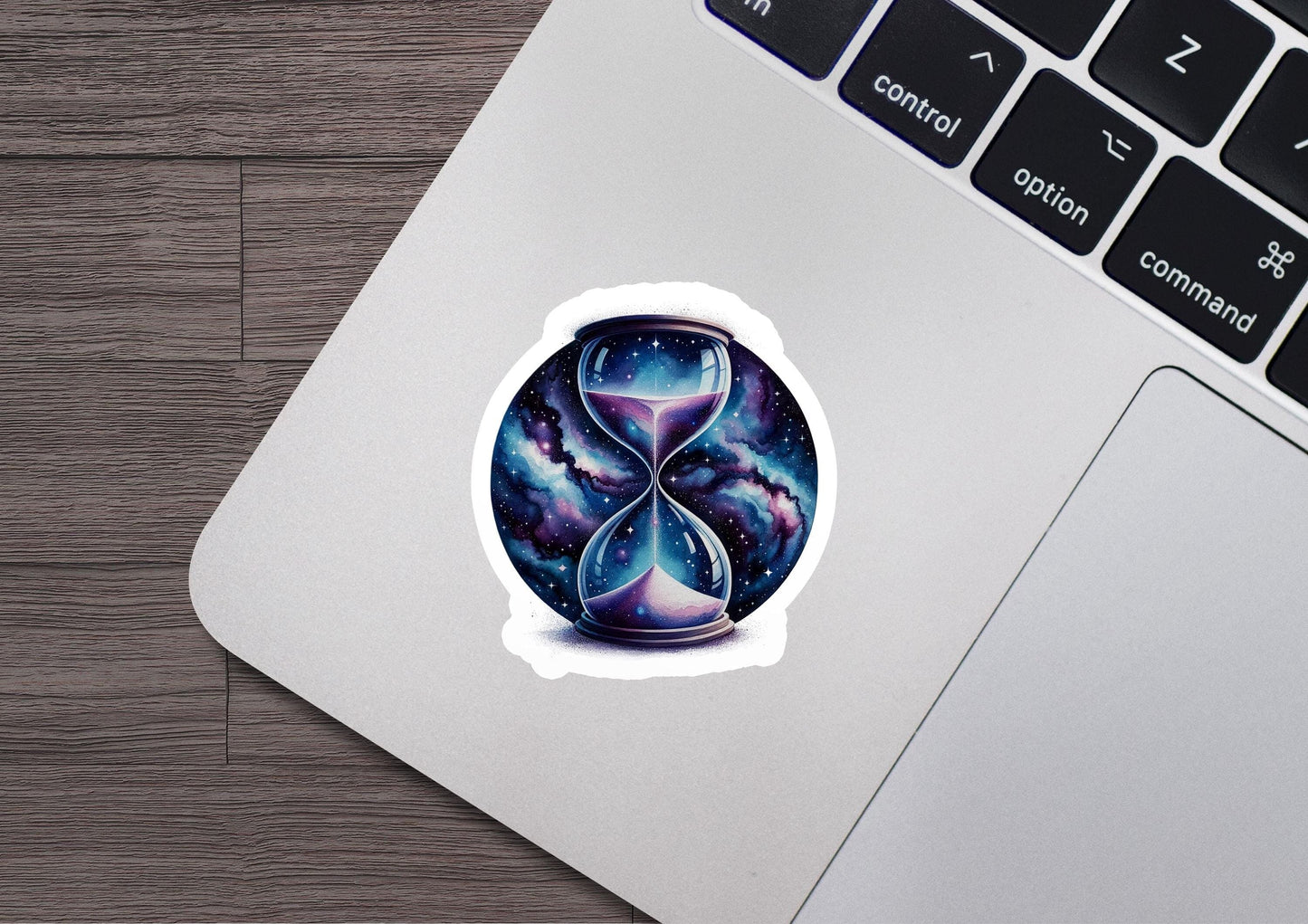 a laptop with a sticker of an hourglass on it