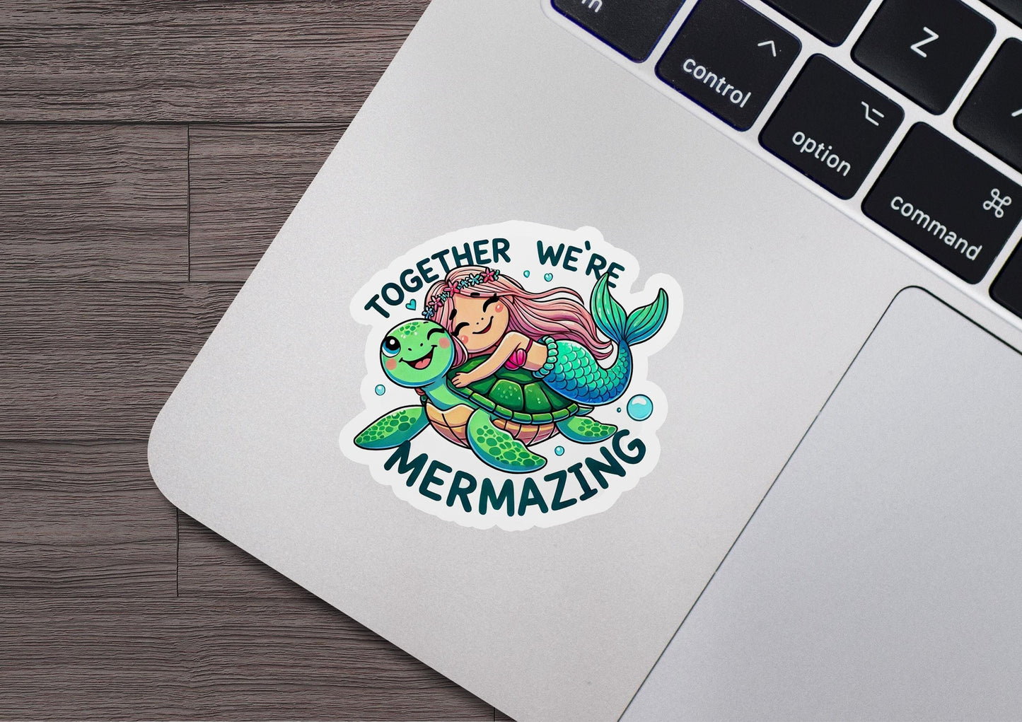 a laptop with a sticker of a mermaid riding a turtle
