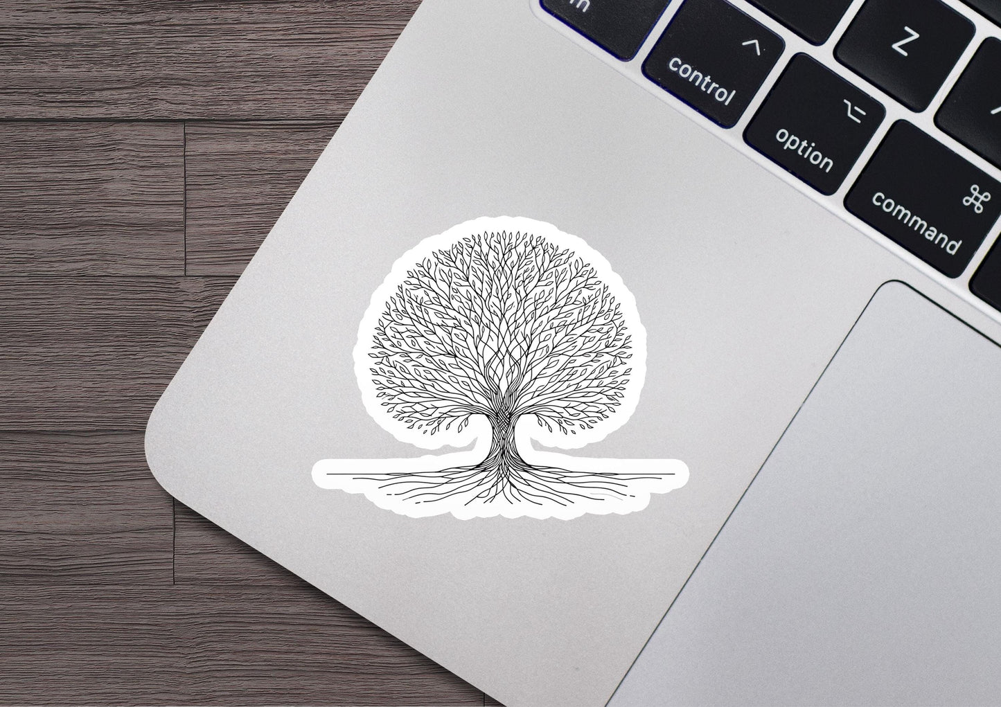 a laptop with a sticker of a tree on it