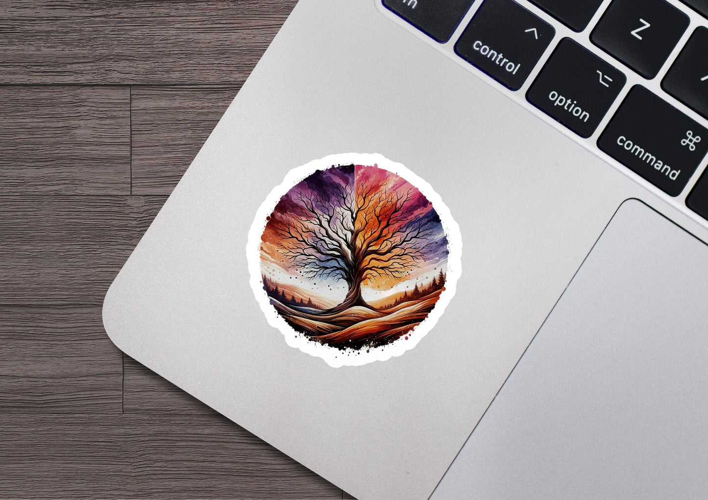 a laptop with a sticker of a tree on it
