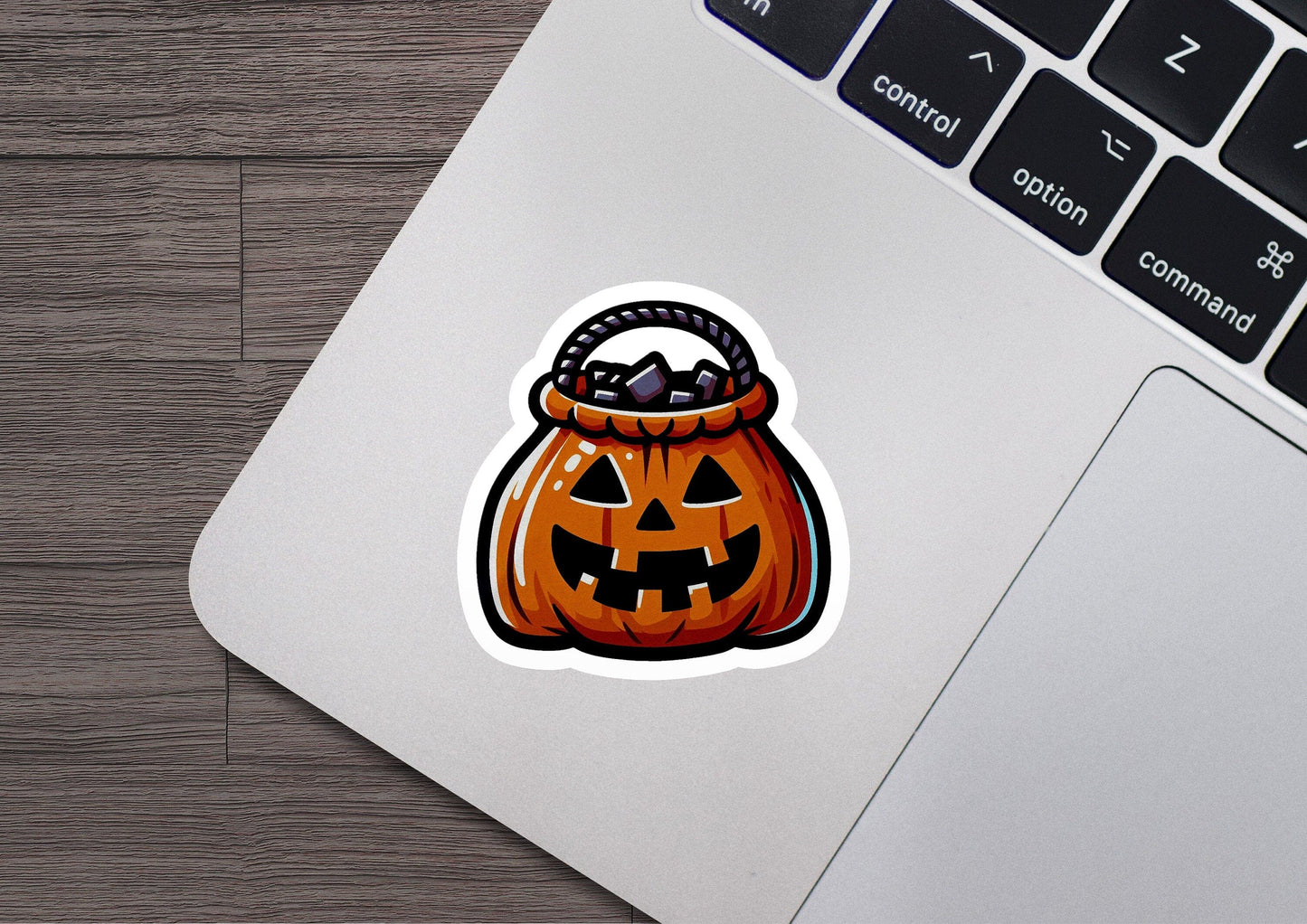 a laptop with a sticker of a pumpkin in a basket