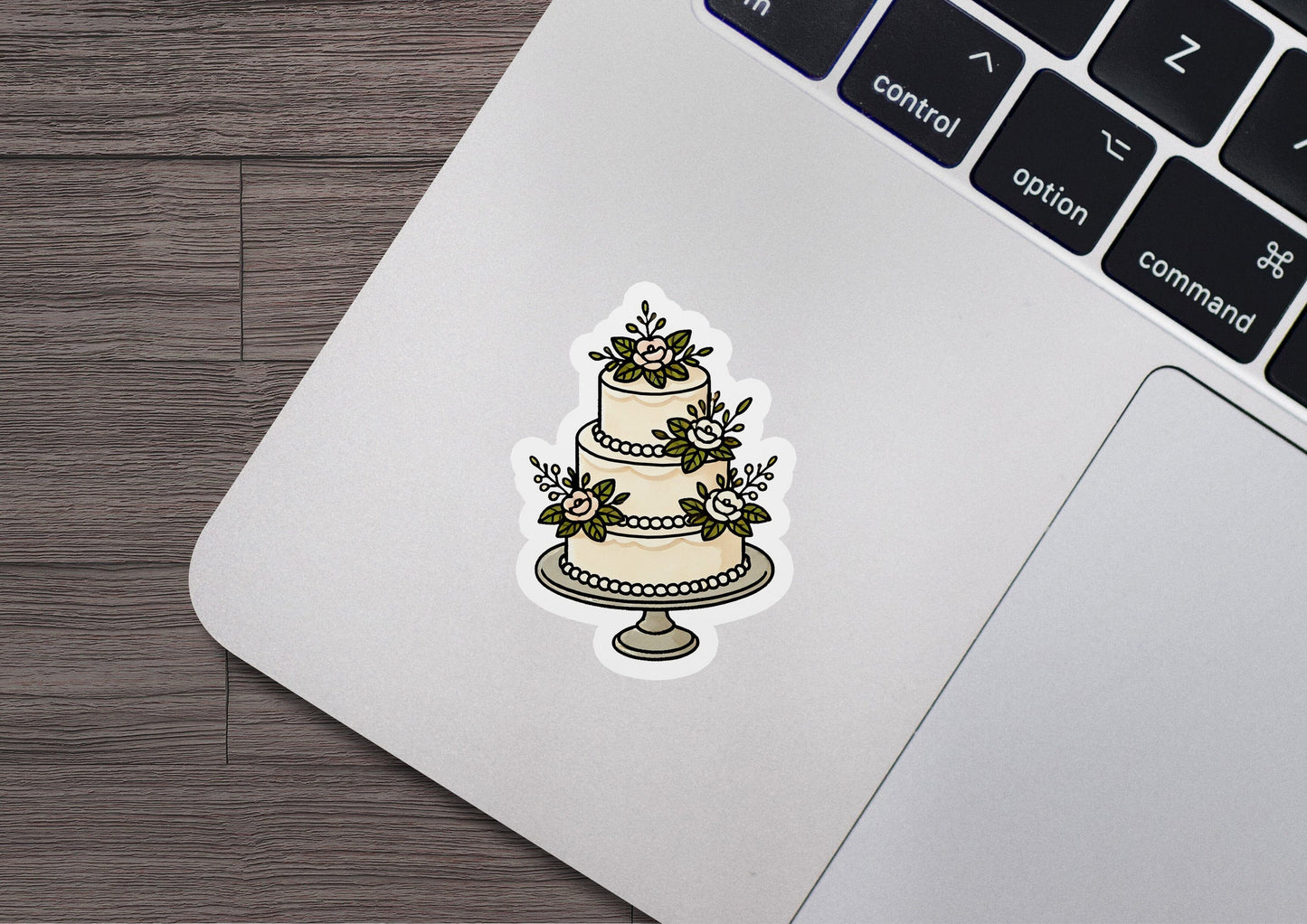 a sticker of a wedding cake on a laptop