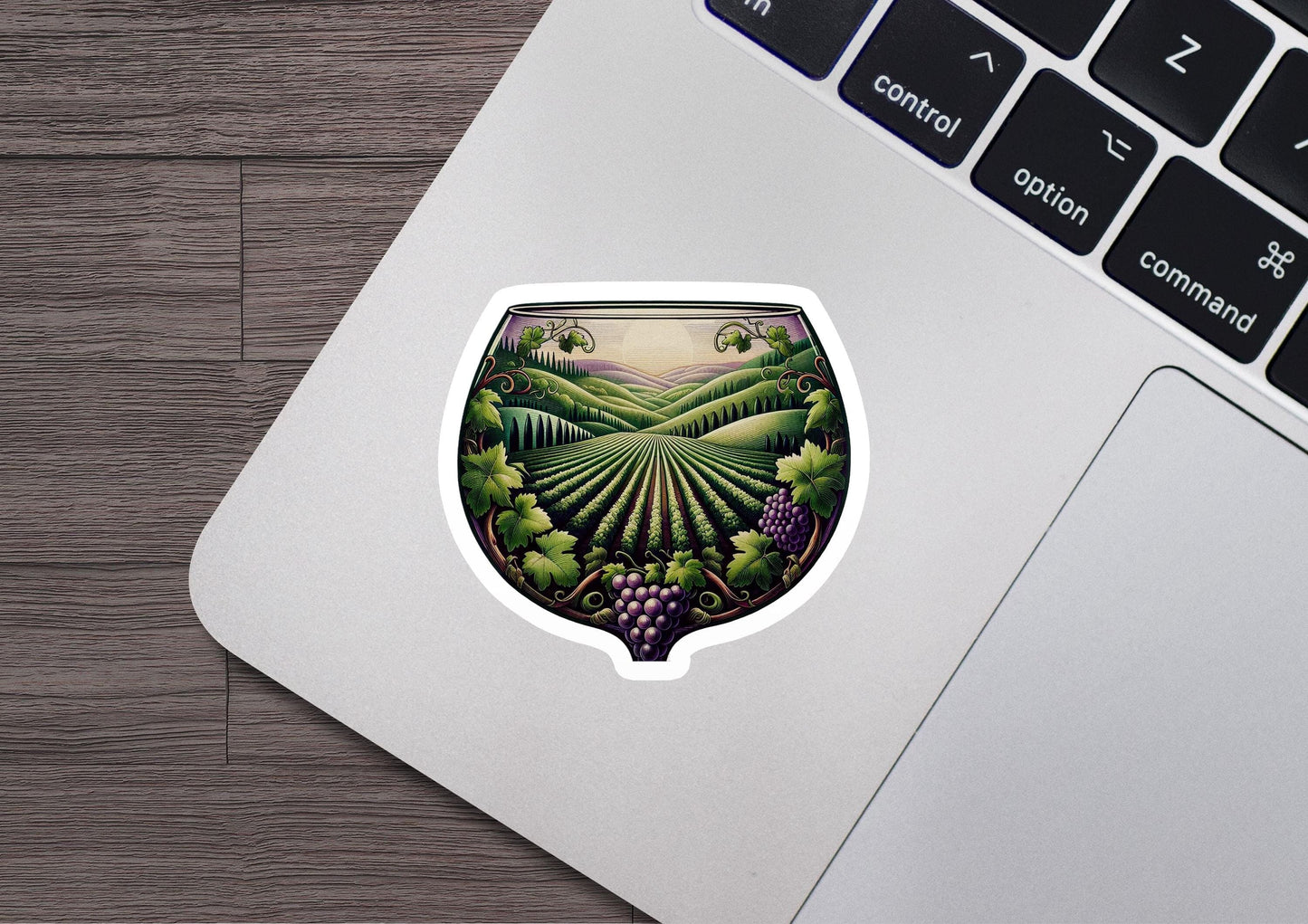 a laptop with a sticker of a vineyard