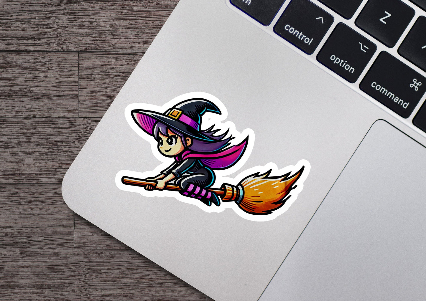 a sticker of a witch riding a broom