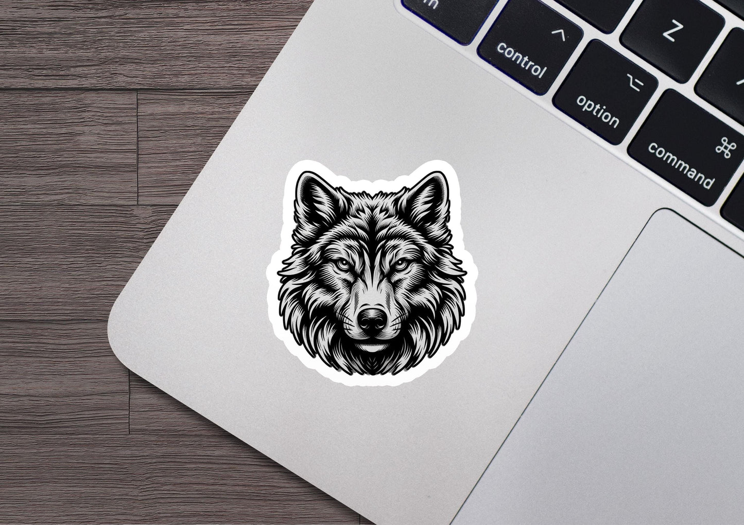 a sticker of a wolf head on a laptop
