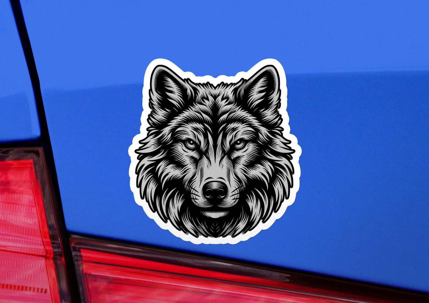a sticker of a wolf head on a blue car