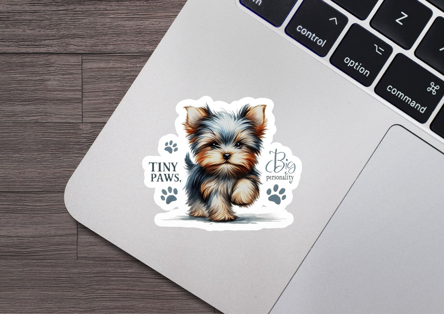 a sticker of a small dog sitting on top of a laptop