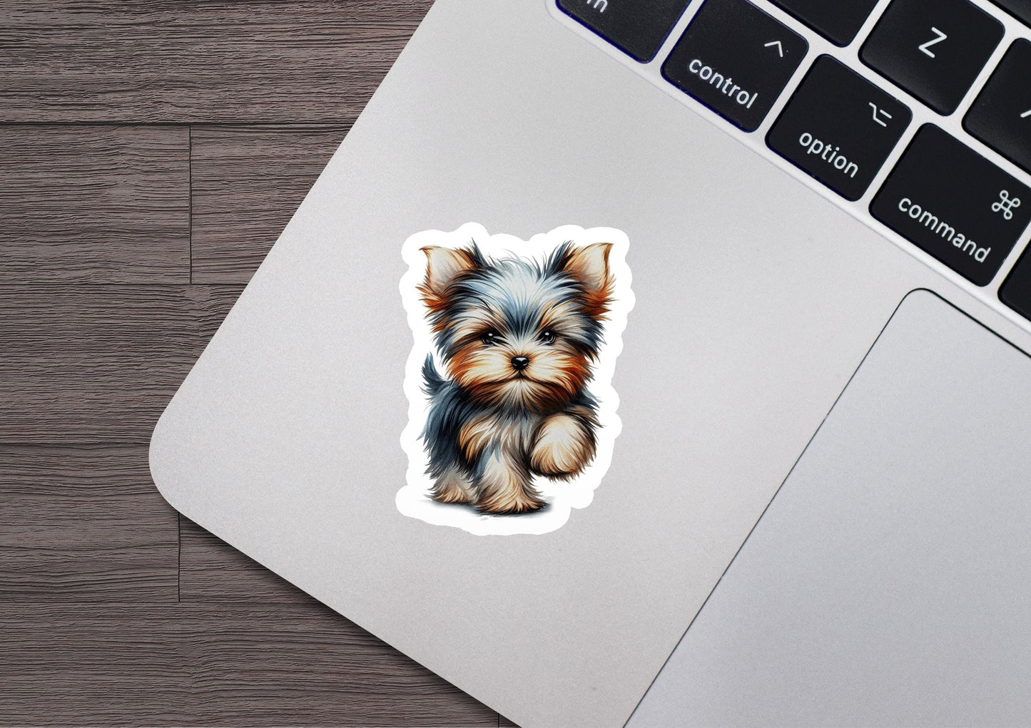 a sticker of a small dog sitting on a laptop