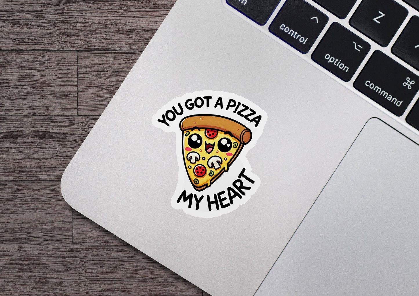 a laptop with a sticker of a slice of pizza on it