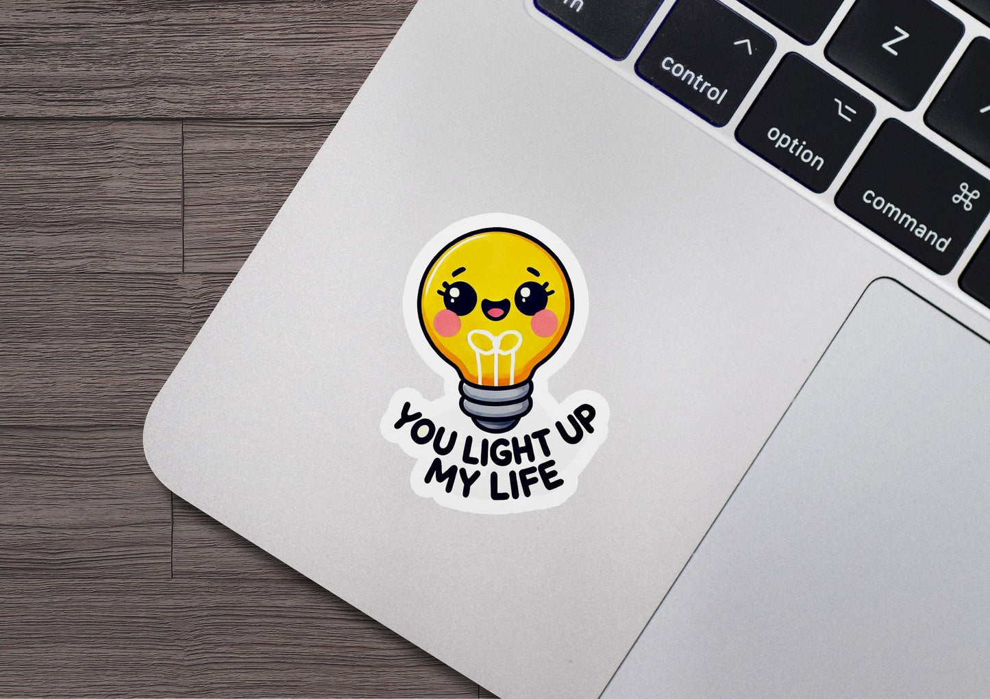 a laptop with a sticker of a light bulb
