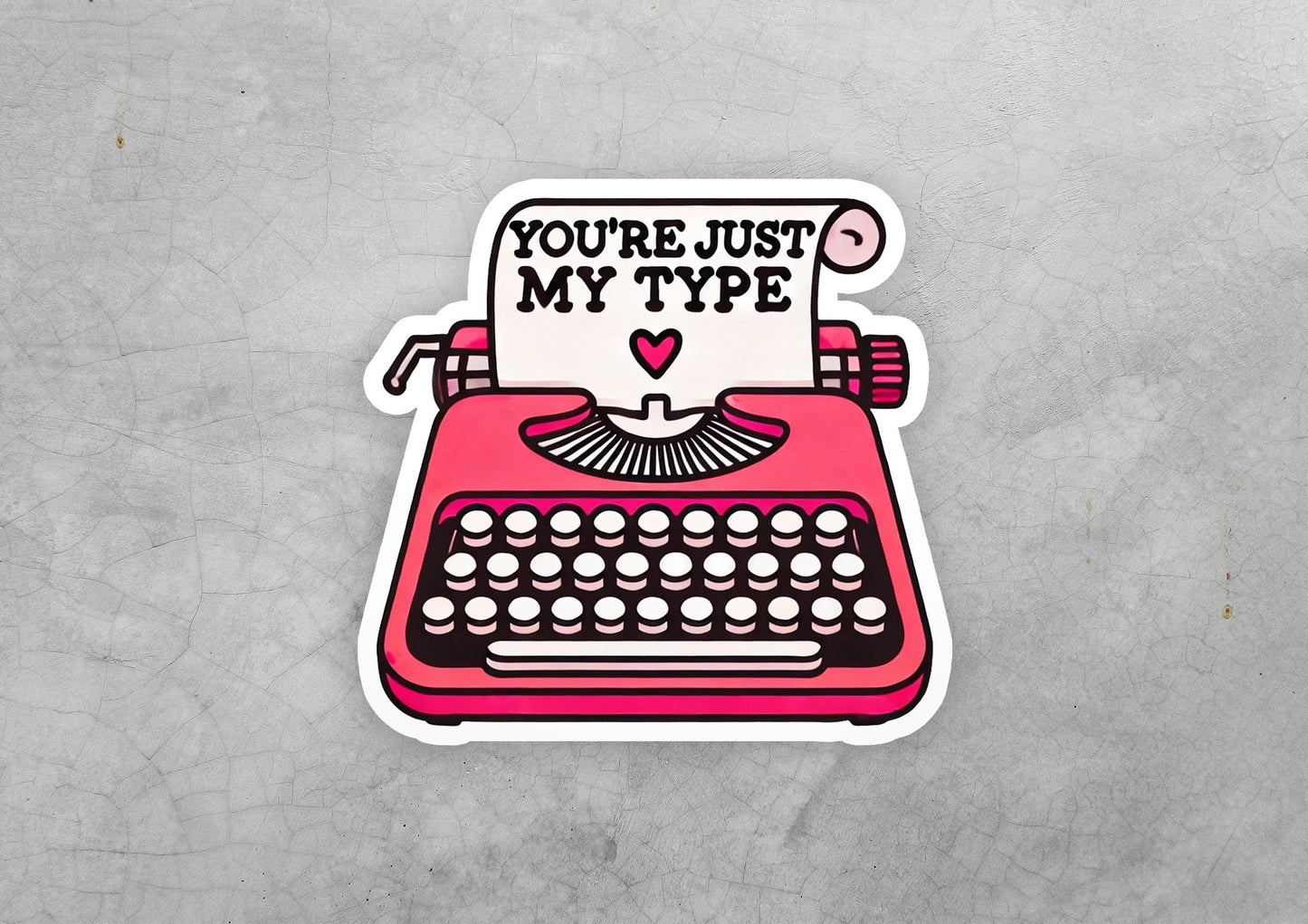 a sticker of a typewriter with the words you're just my type