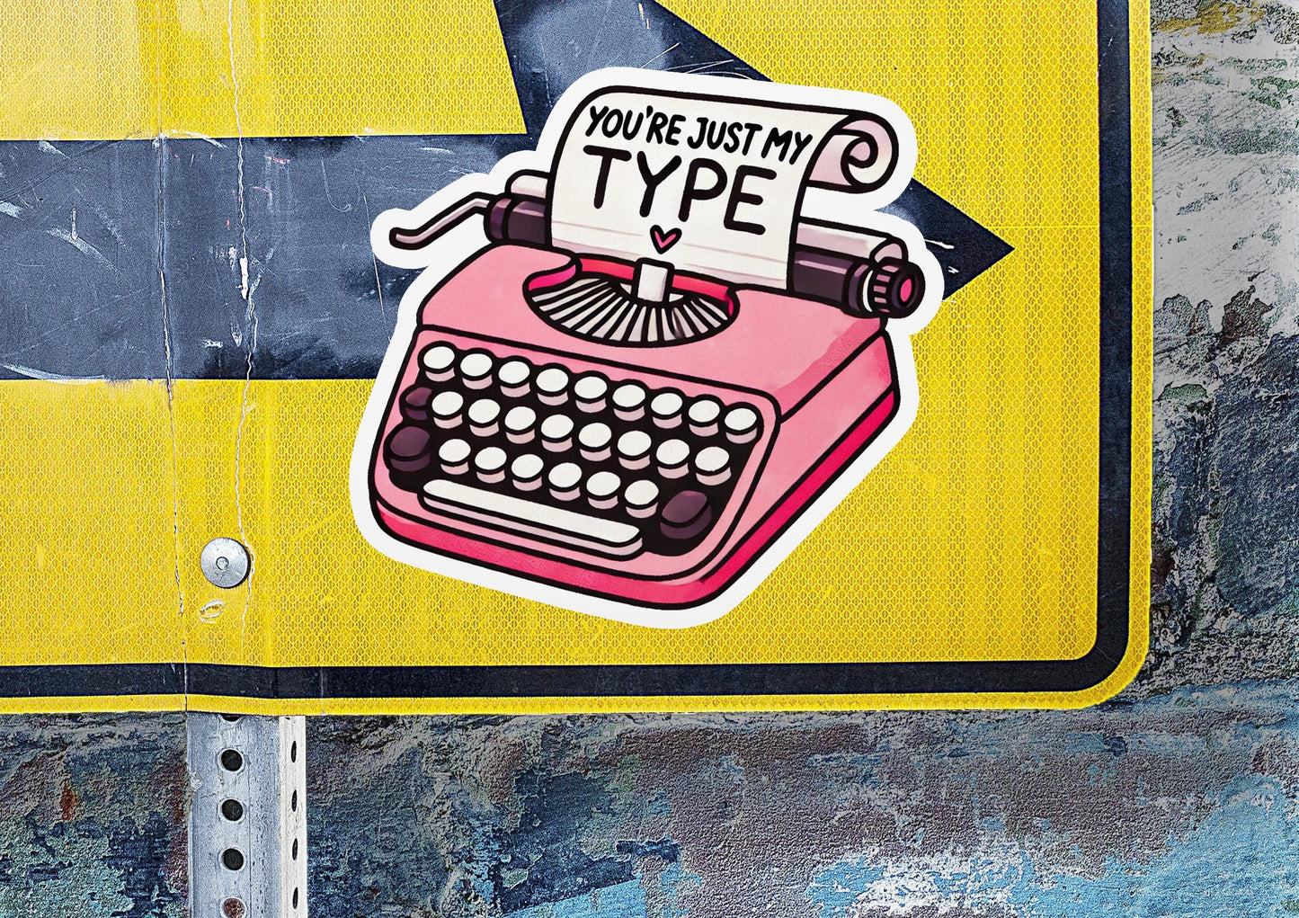 a street sign with a typewriter sticker on it