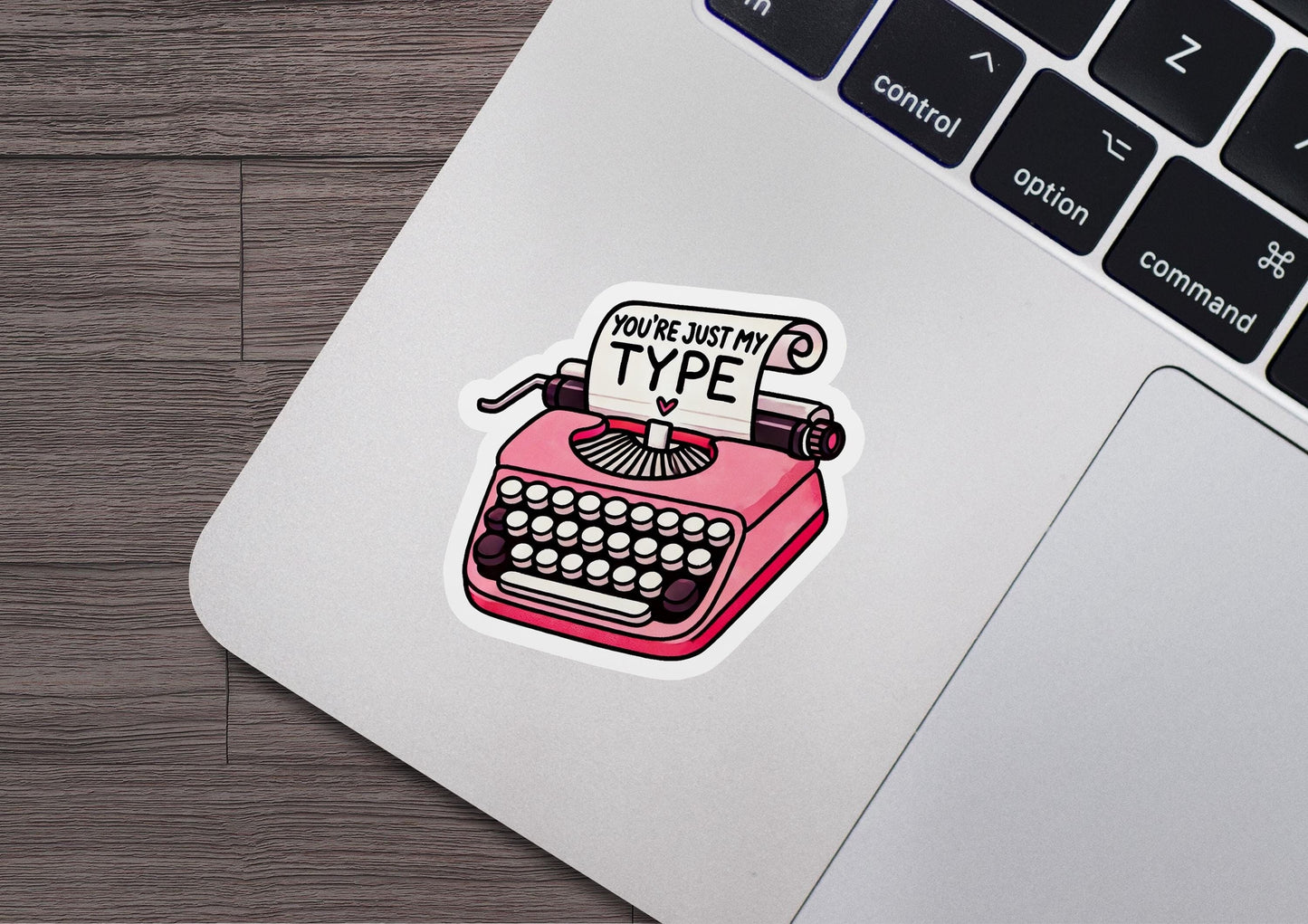 a laptop with a sticker of a typewriter