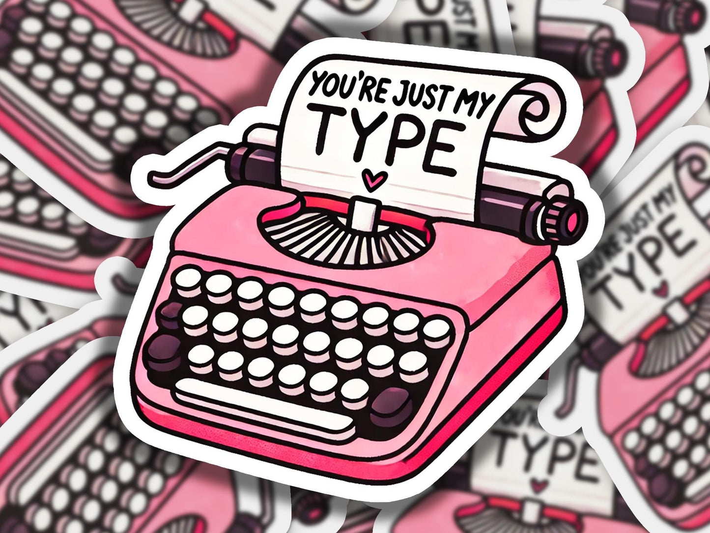 a pile of pink and black typewriter stickers