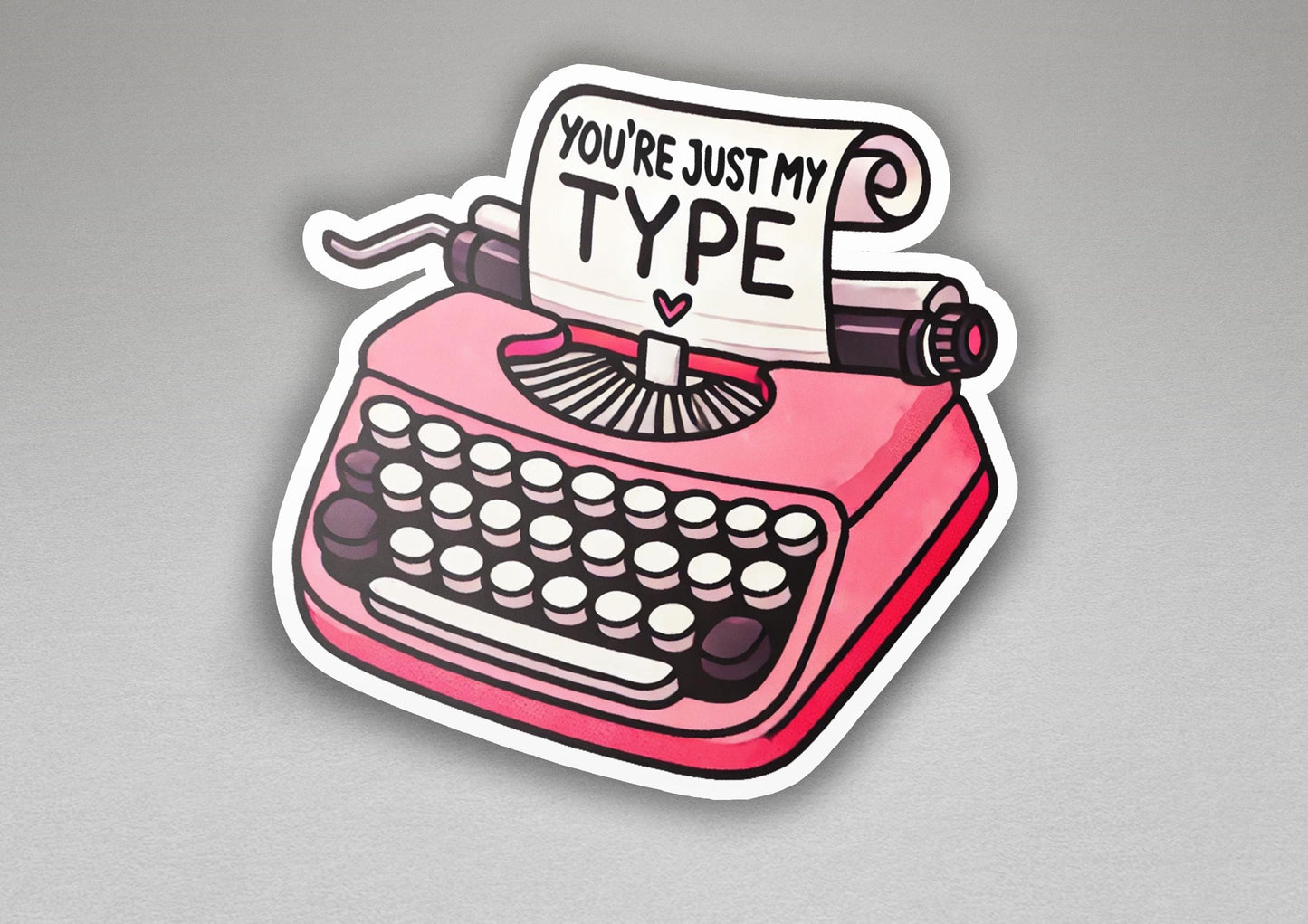 a sticker of a pink typewriter with a sign that says you're