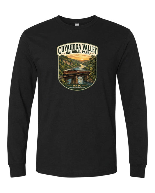 A black long-sleeve t-shirt with a graphic design depicting a scenic view of the Cuyahogah Valley National Park, featuring a bridge, trees, and a sunset over a river.