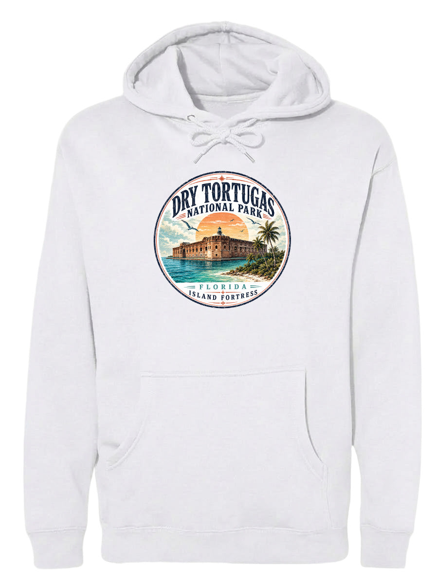 A white hoodie with a circular graphic design featuring a tropical island with a castle, palm trees, and a sunset.