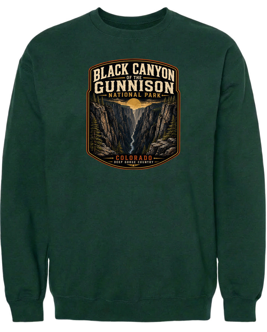 A green sweatshirt with a graphic design depicting the Black Canyon of the Gunnison National Park in Colorado.
