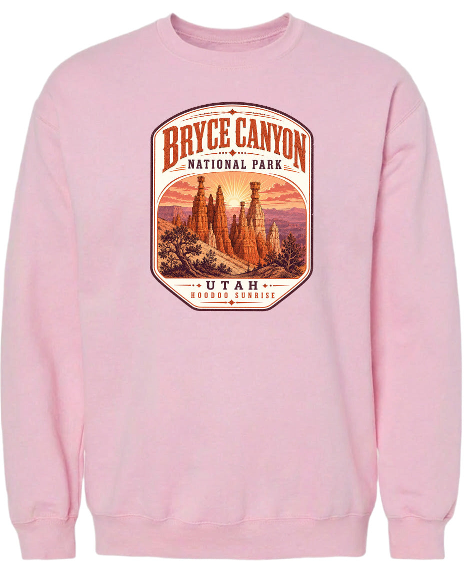 A pink sweatshirt with a graphic design depicting the Bryce Canyon National Park in Utah.