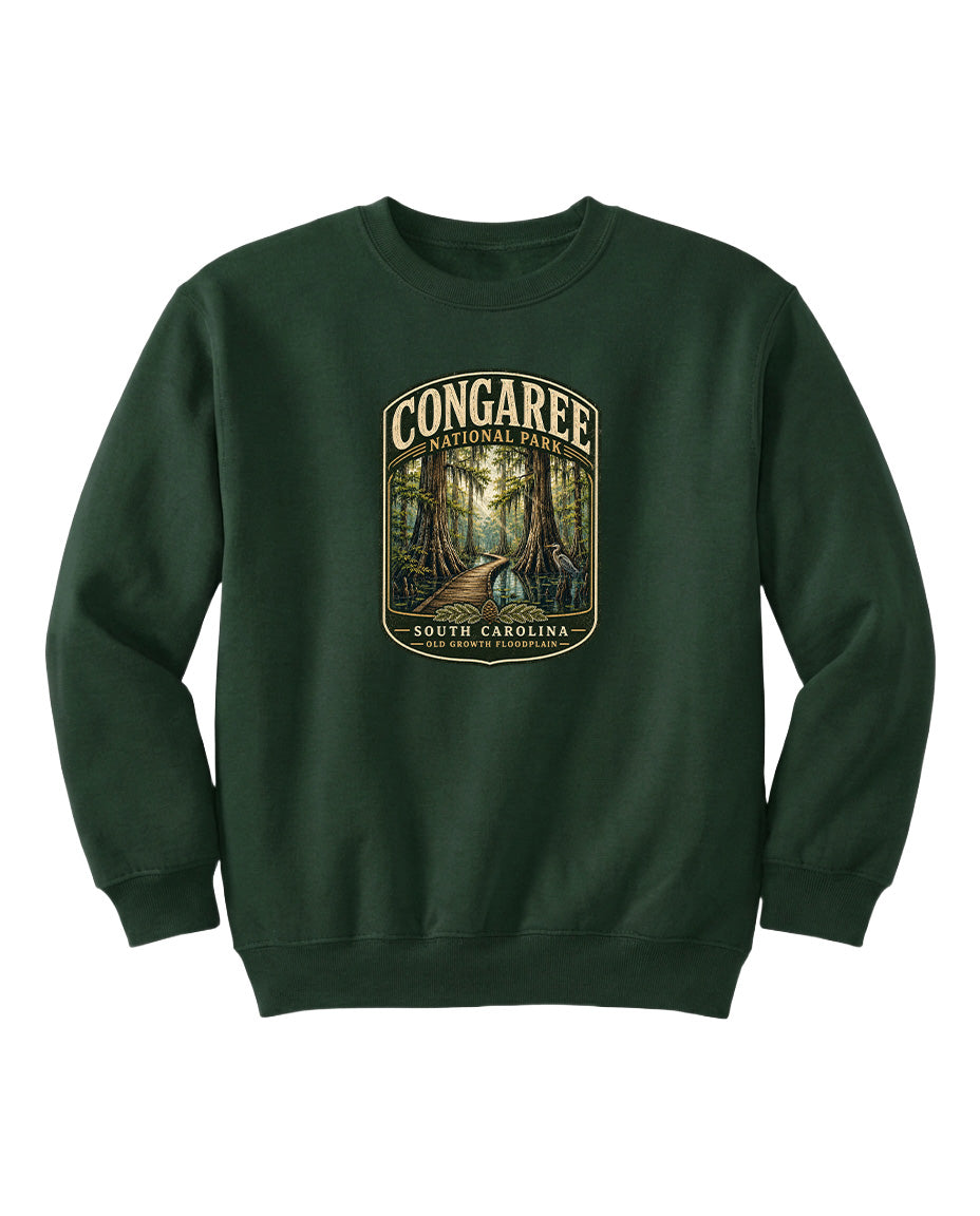 A green sweatshirt with a graphic design depicting a forest scene, featuring the text "CONGAREE NATIONAL PARK SOUTH CAROLINA" prominently displayed.