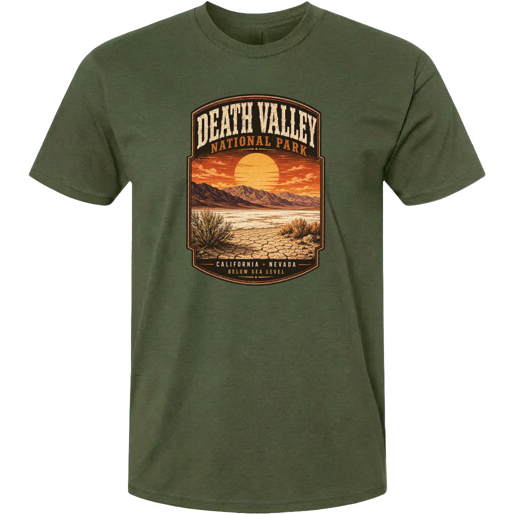 A t-shirt with a graphic design depicting a desert landscape with mountains, a sunset, and a desert plant.